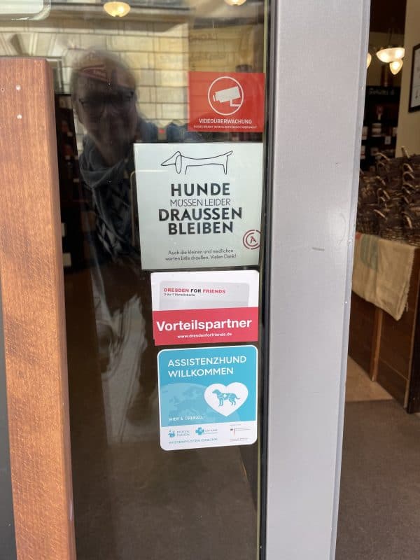 The sticker "Assistance dog welcome" is stuck on the door to the Chocolate Museum.